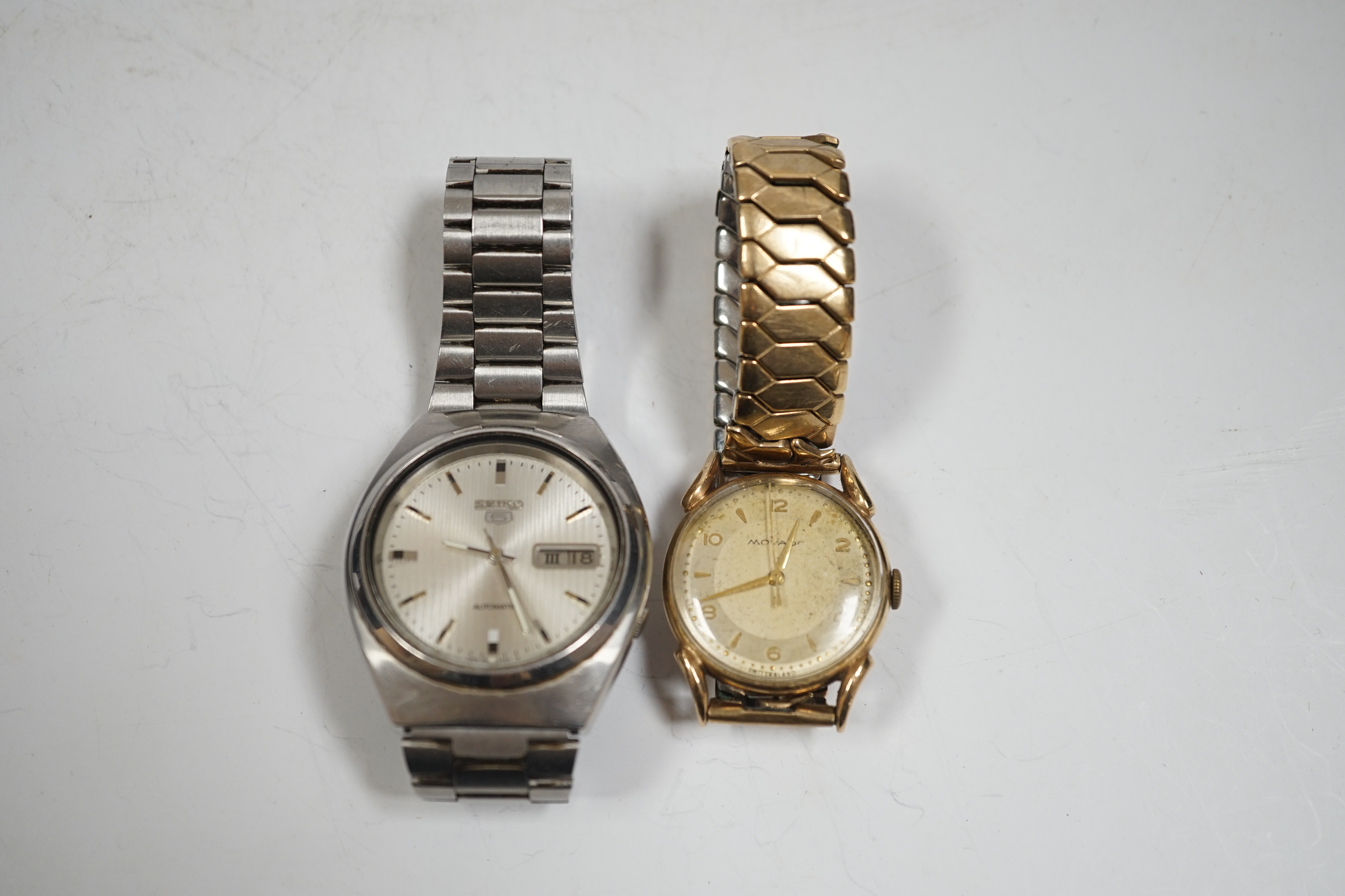 A gentleman's 9ct gold Movado manual wind wrist watch, on associated steel and gold plated flexible strap and a gentleman's stainless steel Seiko 5 automatic wrist watch.